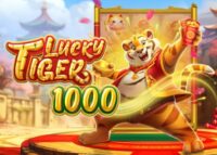 Game cover for 'Lucky Tiger 1000' showing a roaring tiger mascot on a red pedestal with gold trim and a festive, sunlit backdrop.