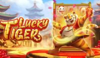 Promotional banner for the Lucky Tiger game showing a tiger hero on a gold stage with red carpet and gold coins surrounding the logo.